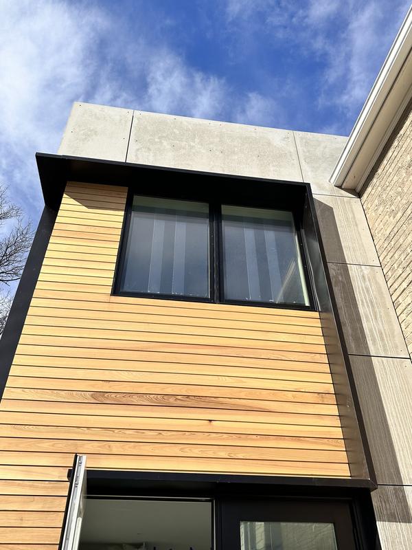 Expansion Art — cedar siding and black-framed window