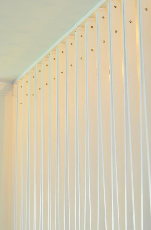 From Safety to Sculpture — ribs meeting the ceiling with brass fasteners