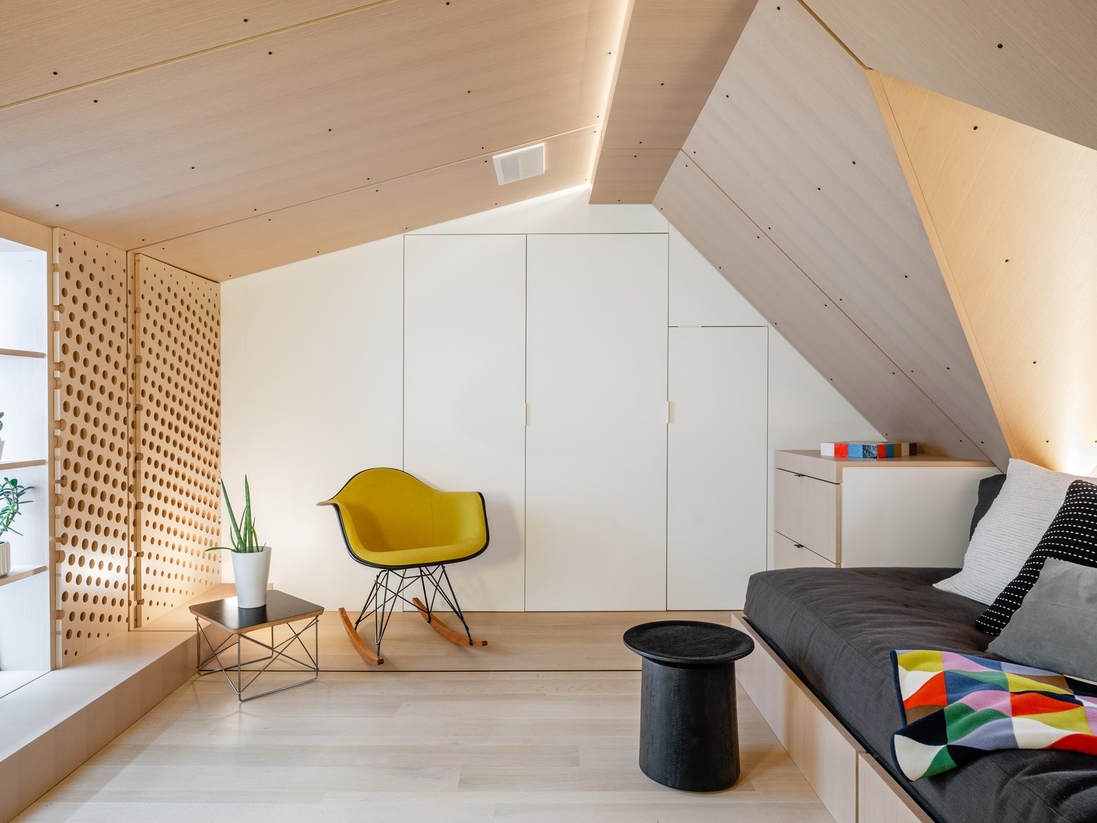 The same wall, now a wardrobe and a reading chair