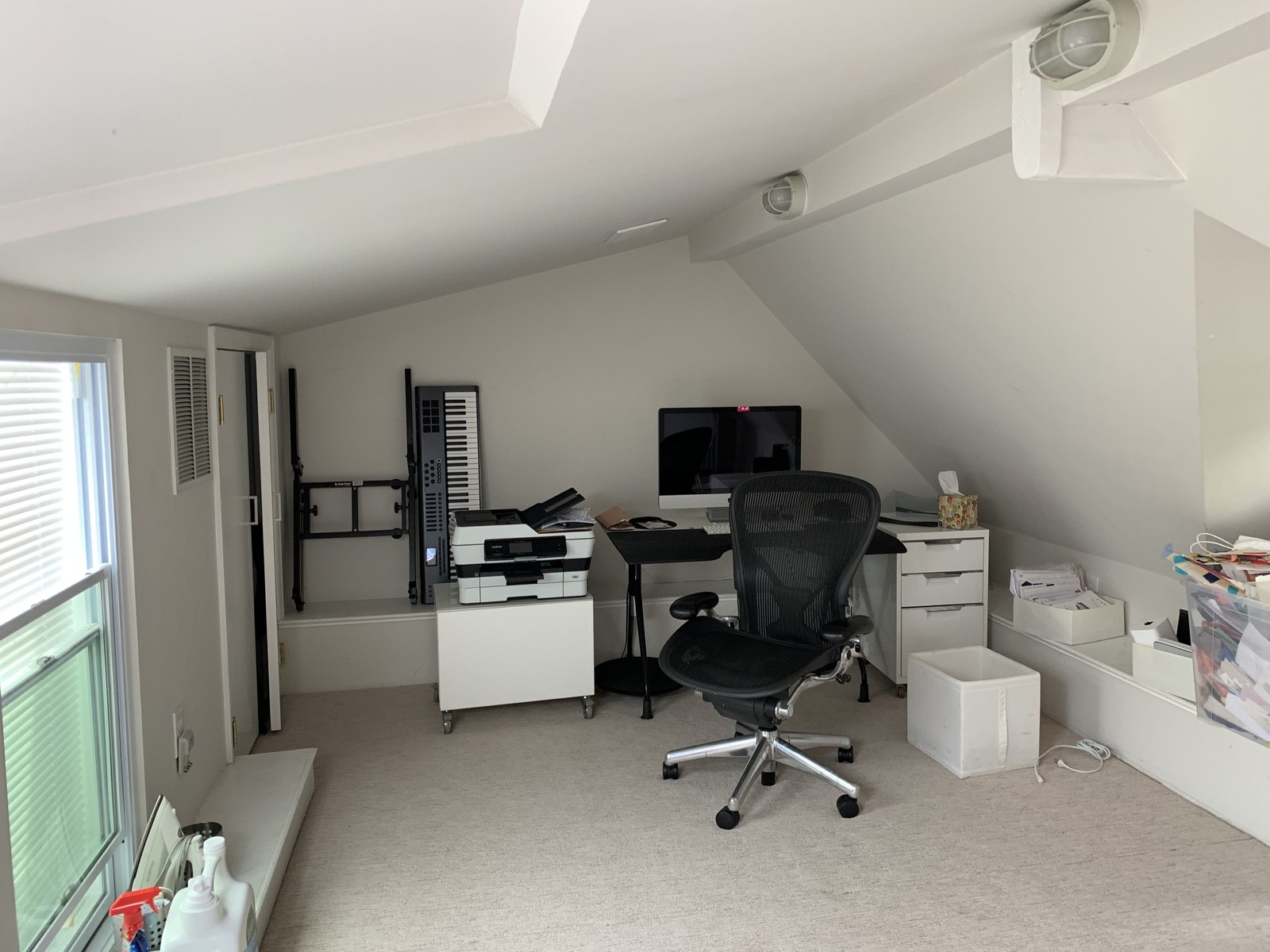 The unfinished attic office before, cluttered and low-ceilinged