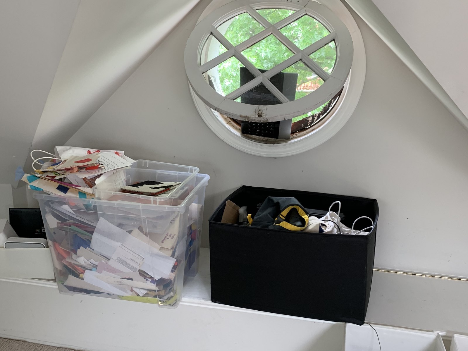 The original round window before, over stacked storage bins