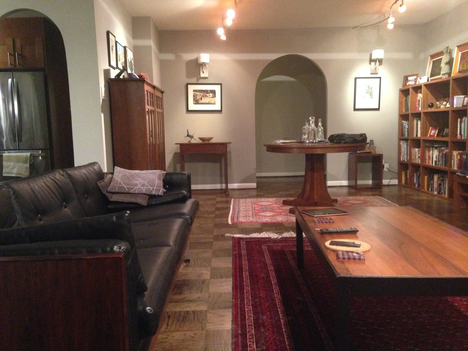 The living room before, dark and boxed in behind two arched openings