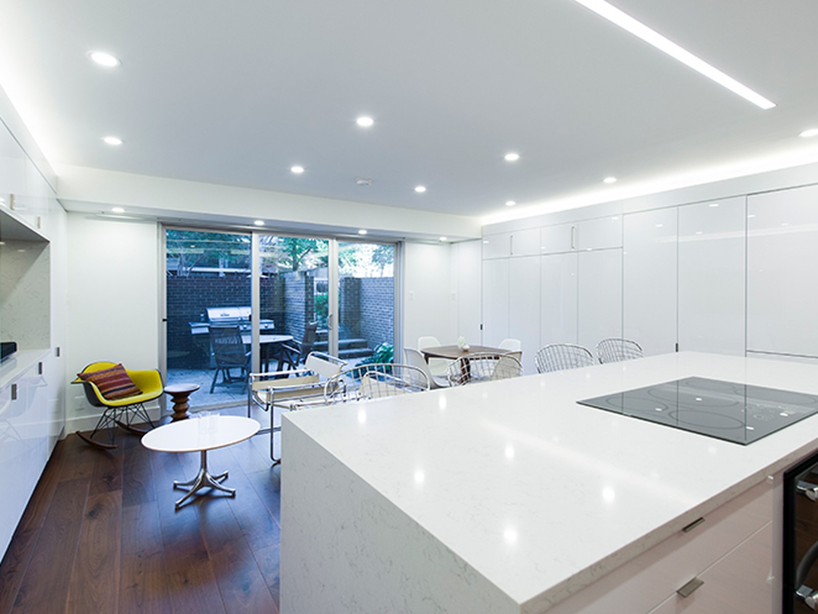 The same footprint after, an open kitchen and living room with the patio beyond