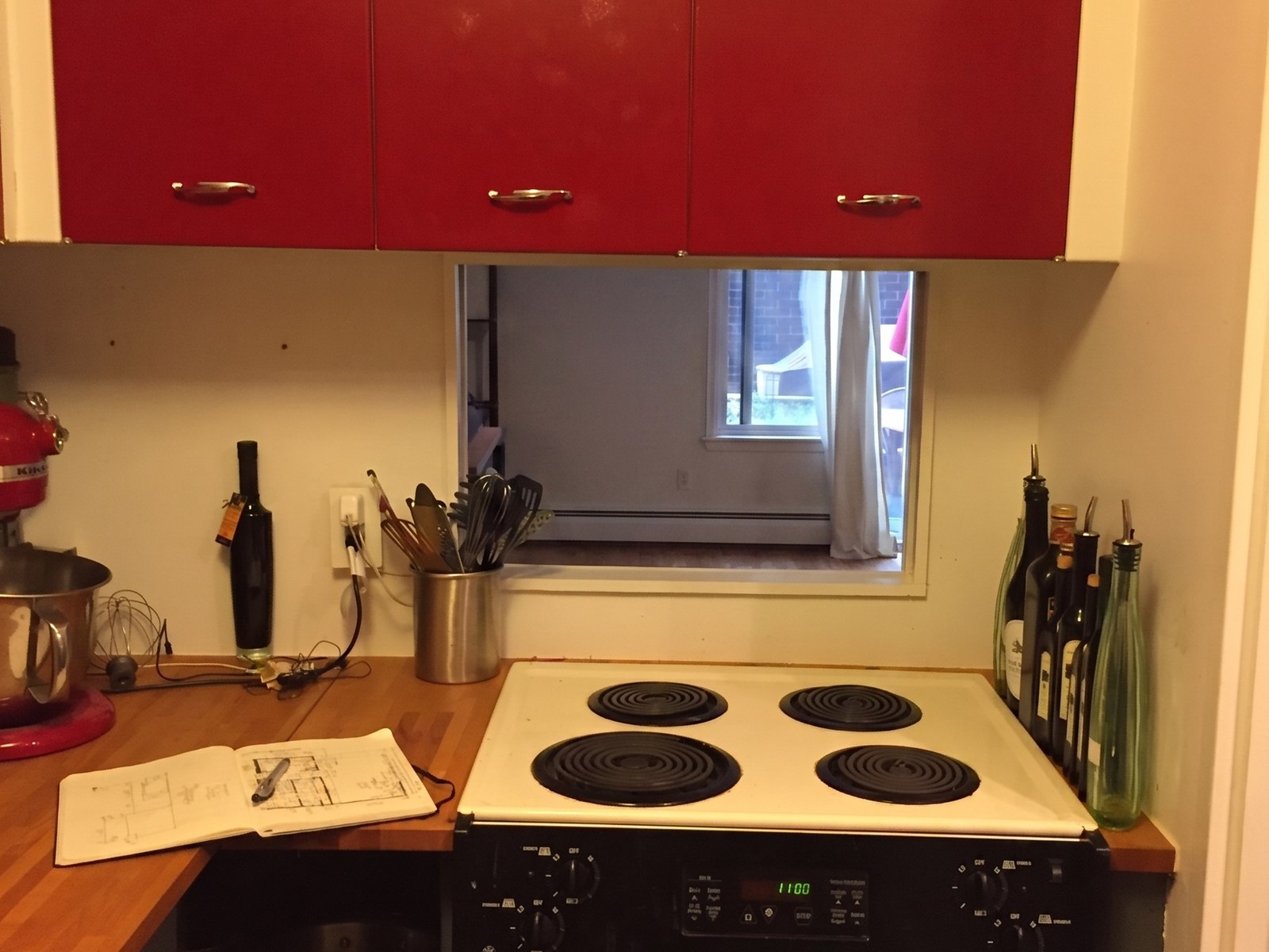 The original 1960s red cabinets before, over an electric stove